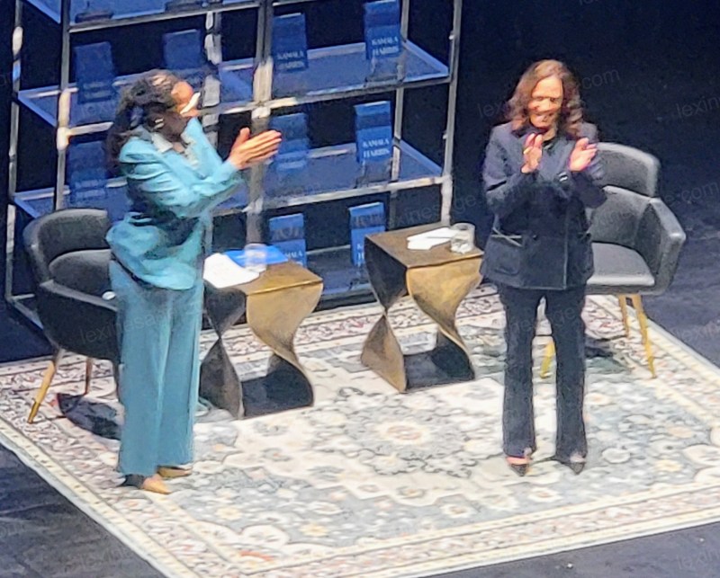 MVP Harris and Congressman Simon applauding after a successful event.